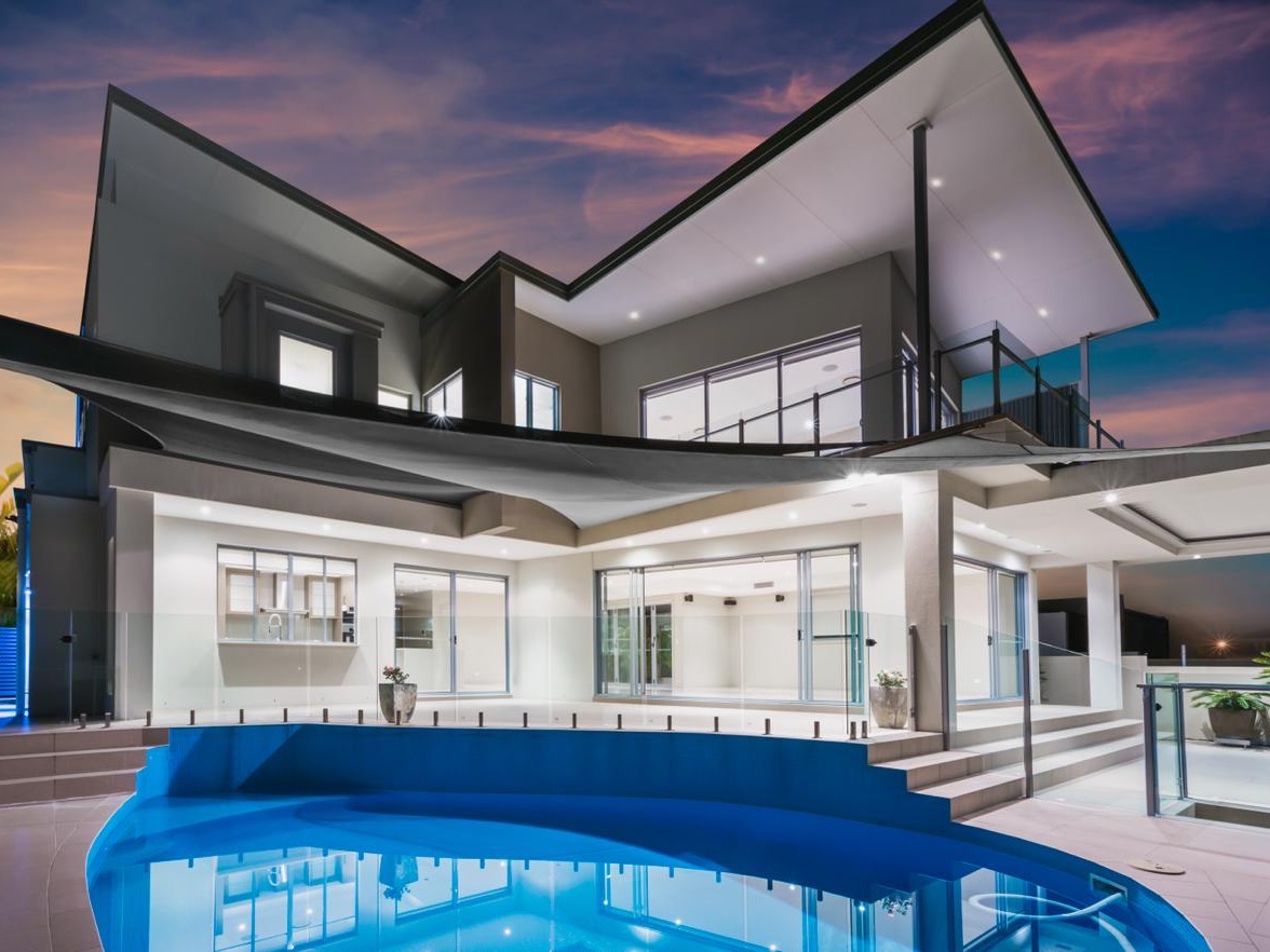 A modern Pretoria home lit up at dusk